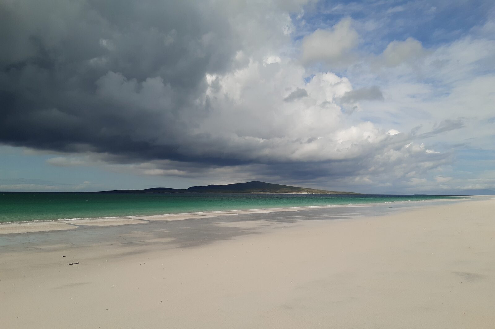 A storm front over an empty Scottish shore — atmosphere for Fractured Thistle
